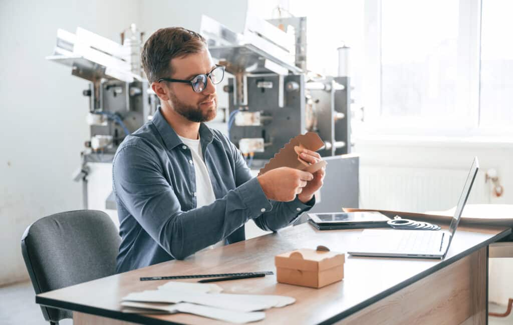 Founder reviewing a sample or prototype at a desk