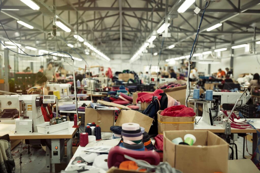 Rows of workers and sewing machines on a busy garment factory floor